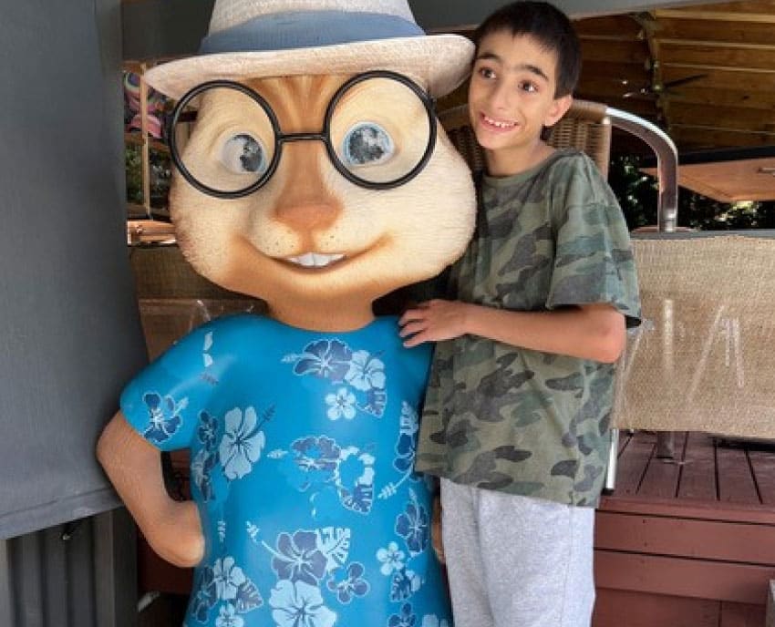 Boy posing with a lifesized model chipmonk at Amazement Farm and Funpark