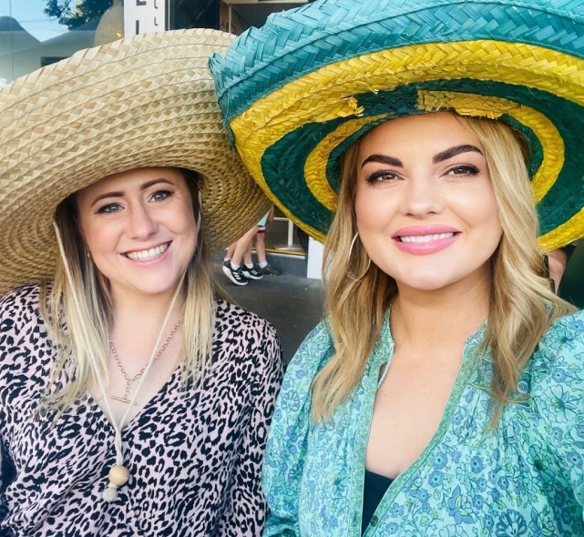 Two members of the Coastlink team wearing sombreros for a themed event