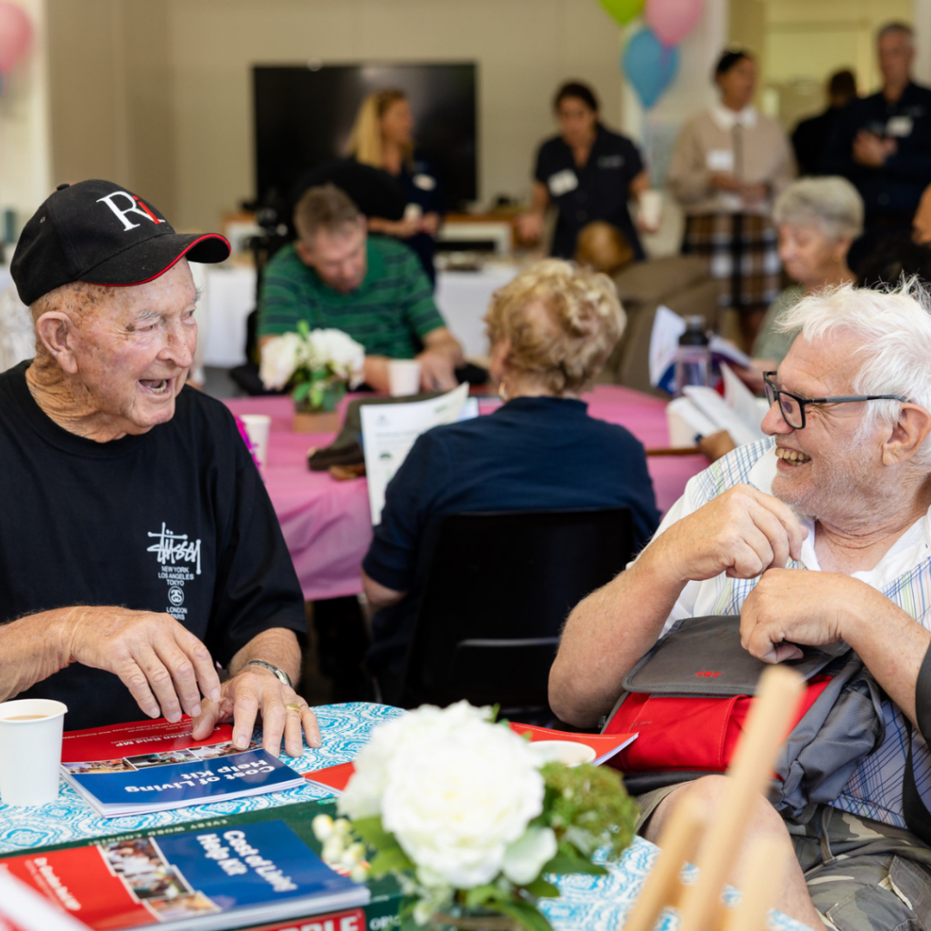 Two men chatting at a Friendship Group event